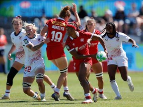 Canada's Charity Williams (centre, with ball) attacks against the U.S. defence on Day 1 of the HSBC SVNS at Cape Town Stadium in a Saturday, Dec. 9, 2023, handout photo.