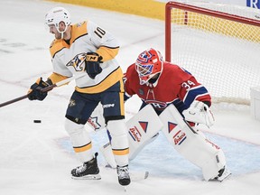 Nashville Predators' Colton Sissons tips the puck past Montreal Canadiens goaltender Jake Allen during first period NHL hockey action in Montreal, Sunday, Dec. 10, 2023.