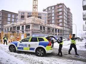 Swedish police arrive at the site where a construction elevator crashed to the ground on a building site seriously injuring several people in Sundbyberg, north of Stockholm, Sweden, Monday Dec. 11, 2023. The construction elevator fell 20 meters (66 feet) with four or five people inside in Sundbyberg, in the north of the city, Kurt Jonsson, a spokesman for the rescue service, told Swedish news agency TT.