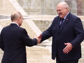 FILE - Belarus' President Alexander Lukashenko, right, and Russian President Vladimir Putin greet each other prior to a session of the Collective Security Treaty Organisation (CSTO) in Minsk, Belarus, on Nov. 23, 2023. The International Red Cross on Friday Dec. 1, 2023 suspended the Belarusian chapter after its head stirred international outrage for boasting that it was actively ferrying Ukrainian children from Russian-controlled areas to Belarus.