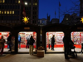 FILE - Shoppers visit the Christmas Village in Philadelphia, Wednesday, Dec. 13, 2023. Holiday sales rose in 2023 as spending remained resilient during the critical shopping season even as shoppers deal with still stubborn inflation in some areas as well as other financial worries, according to one measure.