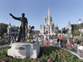 FILE - A statue of Walt Disney and Mickey Mouse appears in front of the Cinderella Castle at the Magic Kingdom theme park at Walt Disney World, Jan. 15, 2020, in Lake Buena Vista, Fla. The earliest version of Disney's most famous character, Mickey Mouse, and arguably the most iconic character in American pop culture, will become public domain on Jan. 1, 2024.