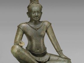 This August 2006 photo shows a late 10th to early 11th century sculpture titled "The Bodhisattva Avalokiteshvara Seated in Royal Ease" at the Metropolitan Museum of Art in New York. The sculpture is one of 16 pieces of artwork that the museum said it will return to Cambodia and Thailand that federal prosecutors say were tied to an art dealer and collector accused of running a huge antiquities trafficking network out of Southeast Asia.