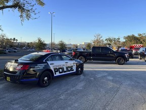 In this photo provided by the Ocala Police Department, a cruiser sits parked following a fatal shooting at Paddock Mall in Ocala, Fla., located about 80 miles northwest of Orlando, Saturday, Dec. 23, 2023.