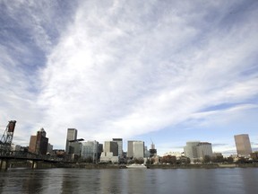 FILE - The Portland, Ore., skyline is visible on the bank of the Willamette River, Dec. 3, 2014. A state appeals court in Oregon ruled Wednesday, Dec. 20, 2023, that a state program designed to limit and drastically reduce greenhouse gas emissions from fossil fuel companies is invalid.
