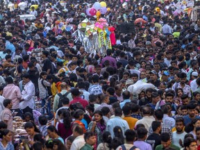 People crowd a market in Mumbai, India.