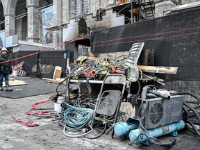 Charred construction equipment is shown at the Notre Dame Basilica in Montreal, Sunday, Dec. 24, 2023, after a fire at the historic site.