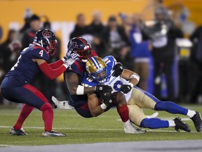 Winnipeg Blue Bombers wide receiver Nic Demski (10) is tackled by Montreal Alouettes linebacker Darnell Sankey (1) and defensive back Ciante Evans (4) during 110th CFL Grey Cup football action in Hamilton, Ont., on Sunday, November 19, 2023. Sankey has signed a two-year contract extension with the Grey Cup-champion Alouettes.