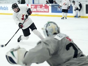 Canada forward Owen Beck shoots on goalie Mathis Rousseau during the Canadian World Juniors selection camp in Oakville, Ont., on Monday, December 11, 2023. Beck scored twice as Canada beat Switzerland 6-2 in a world junior hockey championship tune-up game Friday.THE CANADIAN PRESS/Nathan Denette