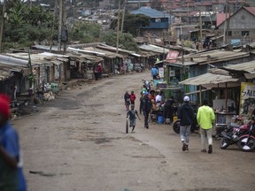 FILE - People walk down a street in Kibera neighborhood, a stronghold of presidential candidate Raila Odinga, in Nairobi, Kenya, on Aug. 11, 2022. A nationwide power blackout hit Kenya Sunday evening, Dec. 11, 2023, paralyzing large parts of the country, including the main airport in the capital, Nairobi, a major transport hub connecting East Africa to Asia, Europe and other parts of the world.