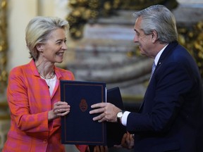 FILE - European Commission President Ursula von der Leyen, left, and Argentina's President Alberto Fernandez, exchange folders during a meeting at the government house in Buenos Aires, Argentina, Tuesday, June 13, 2023. Argentina's outgoing government said Monday, Dec. 4, that it won't support the signing of a long-delayed trade deal between the European Union and the South American bloc Mercosur during a summit this week in Brazil even though the incoming Argentine government has expressed support for the deal.