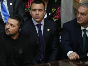 Hungary's Prime Minister Viktor Orban, right, and Ukraine's President Volodymyr Zelenskyy, left, attend the inauguration of Argentina's new President Javier Milei at Congress in Buenos Aires, Argentina, Sunday, Dec. 10, 2023. At center is unidentified.