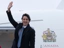 Prime Minister Justin Trudeau waves as he boards a government plane in Ottawa, on Jan. 9, 2023.