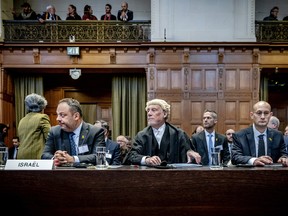 Israel's legal counsellor of the Ministry of Foreign Affairs Tal Becker, lawyer Malcolm Shaw and Gilad Noam, deputy attorney general for international affairs, attend the International Court of Justice prior to a hearing on the genocide case against Israel, in The Hague on Jan. 11.