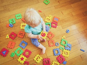 Little girl playing with number puzzles