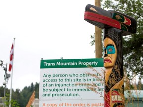 A totem pole is pictured outside the Kinder Morgan Burnaby Terminal and Tank Farm in Burnaby, British Columbia on June 20, 2019.