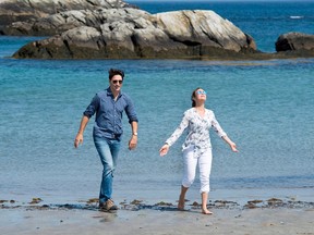 Prime Minister Justin Trudeau and his wife Sophie Gregoire Trudeau walk on the beach at Kejimkujik Seaside National and Historic Park in Port Joli, N.S., on Friday, July 21, 2017.