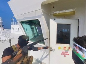 This photo released by the Houthi Media Center shows Houthi forces boarding the cargo ship Galaxy Leader on Sunday, Nov. 19, 2023. Yemen's Houthis have seized the ship in the Red Sea off the coast of Yemen after threatening to seize all vessels owned by Israeli companies.