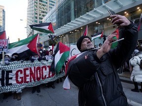 Protesters attend a rally in Toronto on Sunday Jan. 14, 2024.