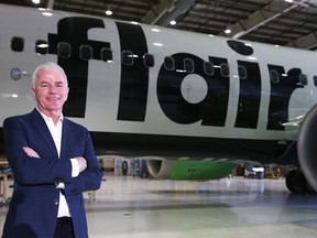 Flair Airlines CEO Stephen Jone standing in front of a Flair airplane.