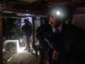 Israeli soldiers inspect a tunnel dug by Hamas.