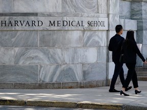Pedestrians walk toward Harvard Medical School
