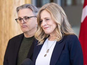 Alberta NDP Leader Rachel Notley announces she is stepping down as leader of the party as her husband Lou Arab listens on Tuesday, Jan. 16, 2024 in Edmonton.