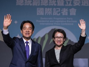 Taiwanese Vice President Lai Ching-te, also known as William Lai, left, celebrates his victory with running mate Bi-khim Hsiao