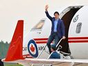 Prime Minister Justin Trudeau waves as he steps off a plane, Wednesday, June 14, 2023 at CFB Bagotville in Saguenay, Que. The plane that flew Trudeau to Jamaica for a family vacation broke down earlier this week, prompting the Canadian military to send a second aircraft with a repair crew to the Caribbean island. 