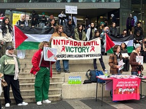 Members of the Palestinian Youth Movement protest outside Toronto Metropolitan University.