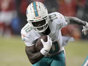 Miami Dolphins wide receiver Tyreek Hill runs for a touchdown against the Kansas City Chiefs during the first half of an NFL wild-card playoff football game Saturday, Jan. 13, 2024, in Kansas City, Mo.