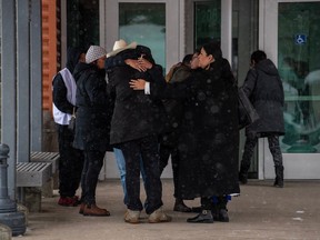 People comfort each other during a lunch break at the public coroner's inquest into the mass stabbings that happened on James Smith Cree Nation in 2022 in Melfort, Sask., Tuesday, January 16, 2024.