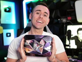 Corey Tonge poses with the plaque he received after hitting his 10 million subscriber mark on YouTube,