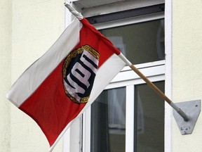 FILE - A party flag is seen on the fassade of the then headquarter of the German right wing party NPD in Berlin, Germany, Thursday, Feb. 7, 2008. Germany's highest court has ruled that a small far-right party will not get any state funding for the coming six years because it's values and goals are unconstitutional and aimed at destroying the country's democracy. The Court said in its ruling the party 'Die Heimat', which used to be known as NPD, "continues to disregard the free democratic basic order and and ... is geared towards its elimination."