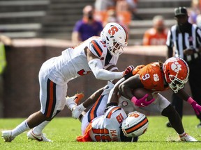 Clemson running back Travis Etienne (9) is tackled by Syracuse defenders Geoff Cantin-Arku (31) and Rob Hanna (19) during an NCAA college football game in Clemson, S.C., on Saturday, Oct. 24, 2020. Cantin-Arku is in Nashville, Tenn., preparing for the Memphis Tigers' pro day in late March/early April. That will be an important audition leading up to the '24 NFL draft April 25-27.