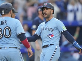 Toronto Blue Jays centre-fielder Kevin Kiermaier (39) celebrates with teammate Alejandro Kirk (30) after scoring during fourth inning American League MLB baseball action against the Tampa Bay Rays in Toronto, Saturday, Sept. 30, 2023. Kiermaier wants to show up all the teams that passed him over in free agency and he wants the Blue Jays to prove all their doubters wrong too.THE CANADIAN PRESS/Frank Gunn