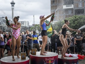 Xantheia Pennisi, left to right, of Australia, Rhiannan Iffland, of Australia, and Canada's Jessica Macaulay celebrate during the final competition day of the rescheduled sixth and final stop of the 2023 Red Bull Cliff Diving World Series in Auckland, New Zealand, in a Sunday, Jan. 28, 2024, handout photo.