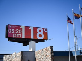 A billboard displays a temperature of 118 degrees Fahrenheit