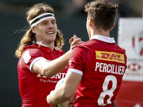 Canada's Thomas Isherwood, left, celebrates his try with teammate Canada's Matthew Percillier during HSBC Canada Sevens rugby action against Mexico in Edmonton, Saturday, Sept. 25, 2021.
