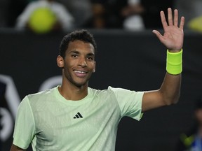 Felix Auger-Aliassime of Canada reacts after defeating Hugo Grenier of France in their second round match at the Australian Open tennis championships at Melbourne Park, Melbourne, Australia, Thursday, Jan. 18, 2024.