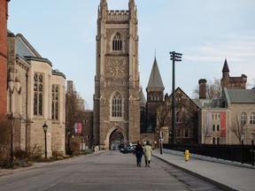 Pedestrians walk through the University of Toronto campus in Toronto.