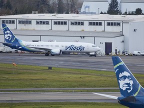 An Alaska Airlines plane outside a hangar.