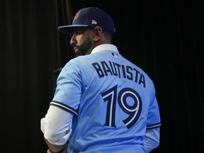 Former Toronto Blue Jays player Jose Bautista attends a news conference in a team shirt bearing his name, in Toronto, Friday, Aug. 11, 2023, after signing a one day contract as the Jays prepare to honour Bautista's legacy. Bautista has bought into Las Vegas Light FC of the United Soccer League.THE CANADIAN PRESS/Chris Young