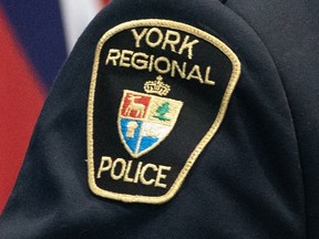 Police say they have charged 11 people with close to 100 offences after a months-long investigation into an alleged car theft ring operating in the Toronto area and other parts of southwestern Ontario.&ampnbsp;A York Regional Police patch is shown in a Dec. 19, 2022 photo in Aurora, Ont.