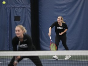 Gabriela Dabrowski, right, and her partner Erin Routliffe take part in a tennis clinic at the Ontario Racquet Club in Mississauga, Ont., on Friday, Dec. 8, 2023. Dabrowski felt a connection "right away" when she started playing doubles with fellow Canadian Routliffe last season.