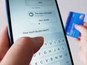A photo of a phone and credit card indicating someone texting about a romance scam