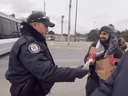 A screen grab from the video shows a Toronto police officer and a protestor who then refers to the police as 