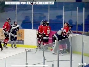 A referee tries to pull Richmond Sockeyes defenceman Eithan Grishin off North Vancouver Wolf Pack goaltender Evan Paul during a fight on Jan. 25.