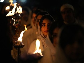 Iranian Zoroastrian youth carry torches to set fire to a prepared pile of wood in a ceremony celebrating their ancient mid-winter Sadeh festival in outskirts of Tehran, Iran, Tuesday, Jan. 30, 2024. Hundreds of Zoroastrian minorities gathered after sunset to mark their ancient feast, creation of fire, dating back to Iran's pre-Islamic past.
