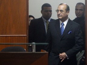 FILE - Peru's former spy chief Vladimiro Montesinos enters the courtroom for a session of former President Alberto Fujimori's trial at a police base in Lima, Peru, June 30, 2008. A Peruvian court on Jan. 31, 2024 sentenced Montesinos, Fujimori's former spy chief, to 19 years and eight months in prison for being the perpetrator of a massacre of six farm workers in 1992.